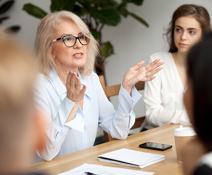 Business woman leading a group meeting in a boardroom.